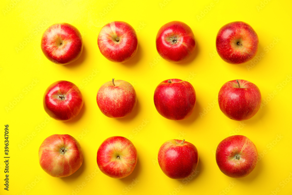 Fresh ripe red apples on yellow background, flat lay Fresh ripe red apples on yellow background, flat lay