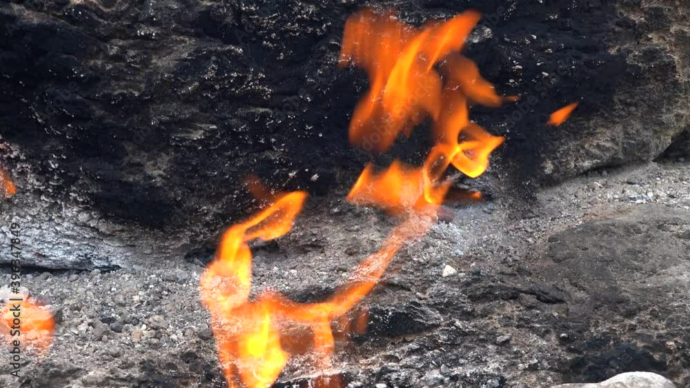 Flame of Methane Underground Emerges From Crack Between Rocks and Burns