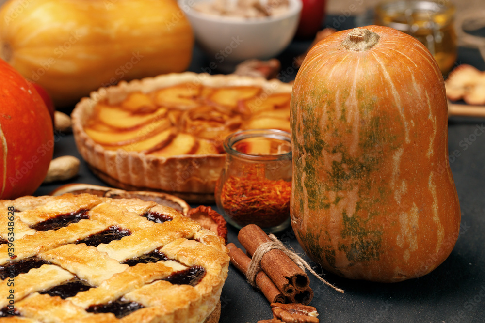 Tart pie and pumpkin on dark black surface Tart pie and pumpkin on dark black surface