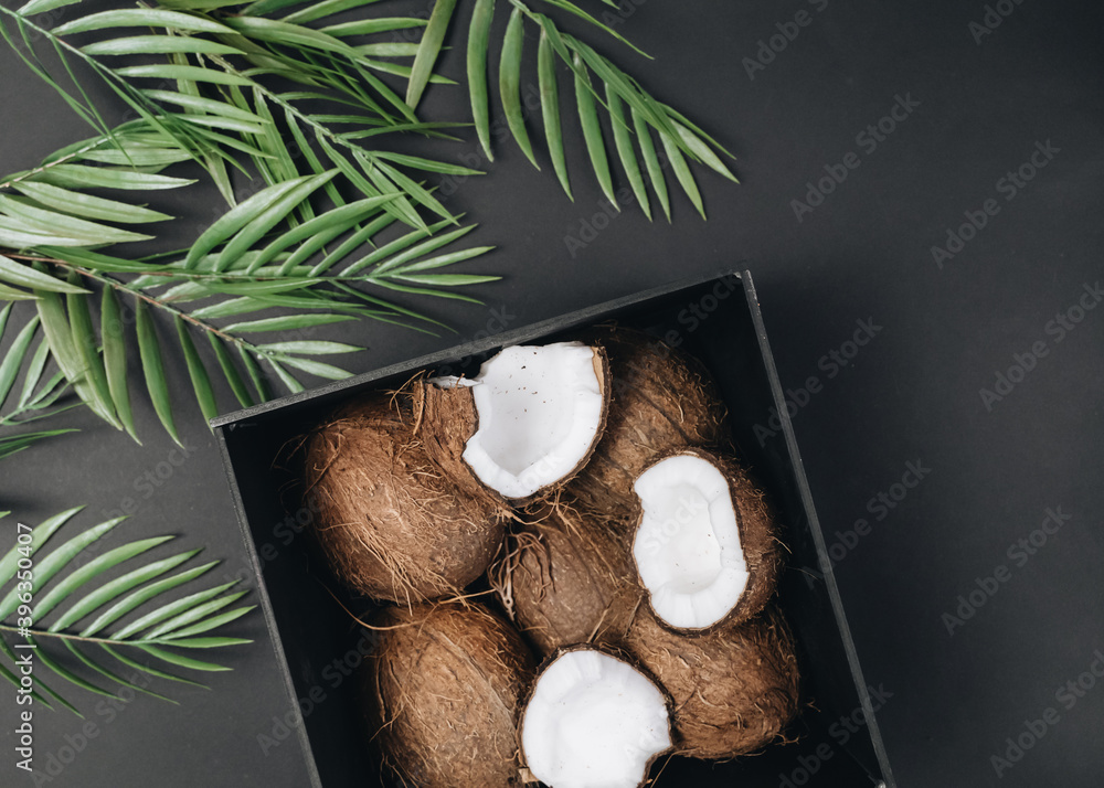 pile of coconuts, tropical fruits on black background pile of coconuts, tropical fruits on black background