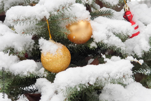 beautiful Christmas decorations on a tree in the snow