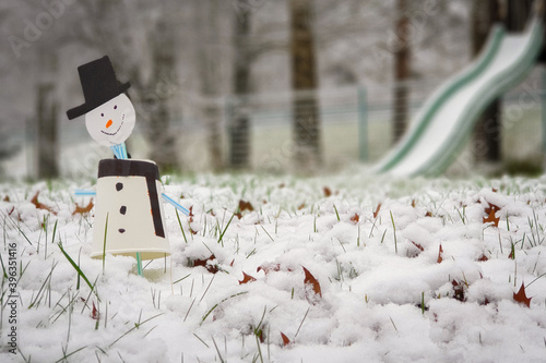Beautiful children's toy snowman in winter