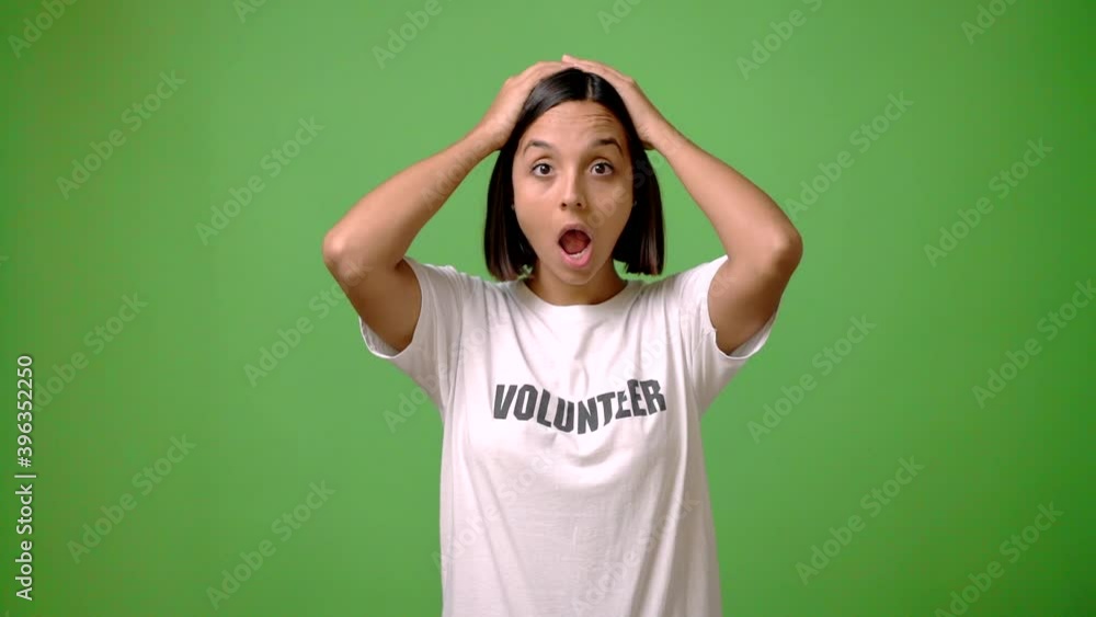 Young volunteer woman on green screen chroma key background intending to realizes the solution while lifting a finger up Young volunteer woman on green screen chroma key background intending to realizes the solution while lifting a finger up
