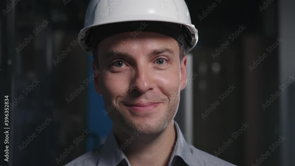 Factory manager in Industrial environment smiles, zoom in Factory manager in Industrial environment smiles, zoom in