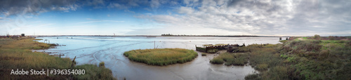 фотография panoramic landscape image of mudflat in essex england