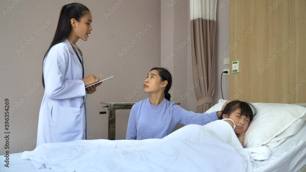 asian girl patient sleeping on bed doctor woman explaining Illness of daughter to mother by tablet in hospital asian girl patient sleeping on bed doctor woman explaining Illness of daughter to mother by tablet in hospital