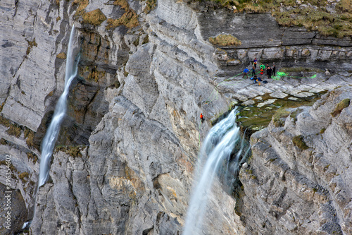 People rappelling 'Salto del Nervion' waterfall. Burg  Alava, Bizkaia. photo