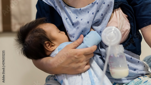mom feed breastmilk and pump milk into bottle