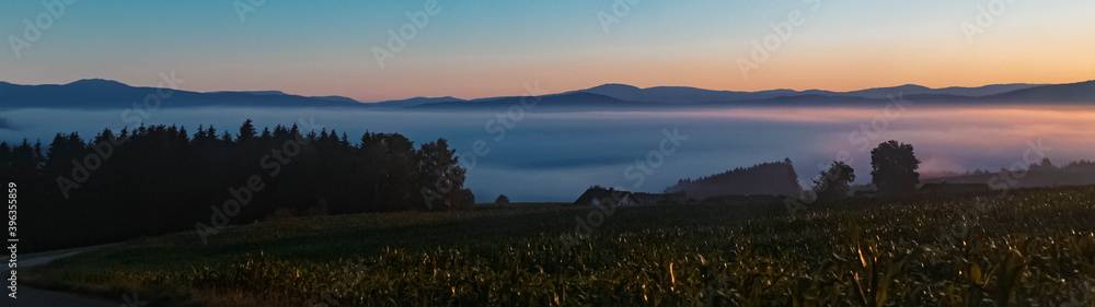 Fototapeta premium Beautiful hazy sunrise at Kirchberg im Wald, Bavarian forest, Bavaria, Germany