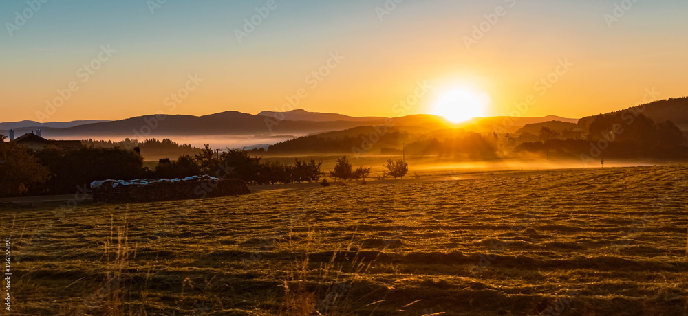 Naklejka premium Beautiful hazy sunrise at Kirchberg im Wald, Bavarian forest, Bavaria, Germany