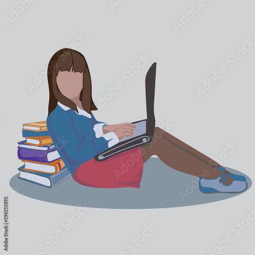 the girl is sitting with books and working on a laptop