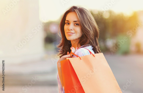 Portrait of attractive young woman with shopping bags in the city