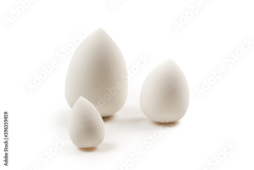Small, medium and large white beauty blender isolated.