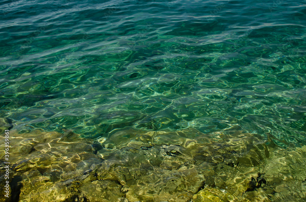 The rocky background of the sea throught emerald water, Croatia