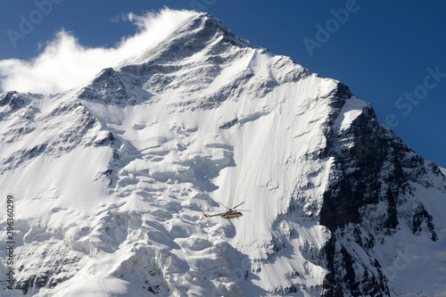 Helicopter against Khan Tengri Peak, Central Tian Shan, Kazakhstan - Kyrgyzstan. photo