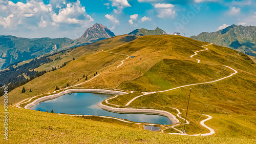 Beautiful alpine summer view with the Grosser Rettenstein summit in the background and a lake at the famous Panoramabahn Kitzbueheler Alpen, Salzburg, Austria photo