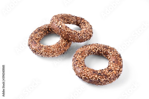 Three sesame seed bagels isolated on white background