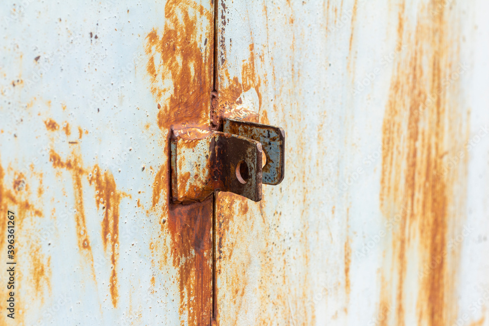 Rust.Fragment of a rusty metal door.Rusty hinges for the lock. Rust.Fragment of a rusty metal door.Rusty hinges for the lock.
