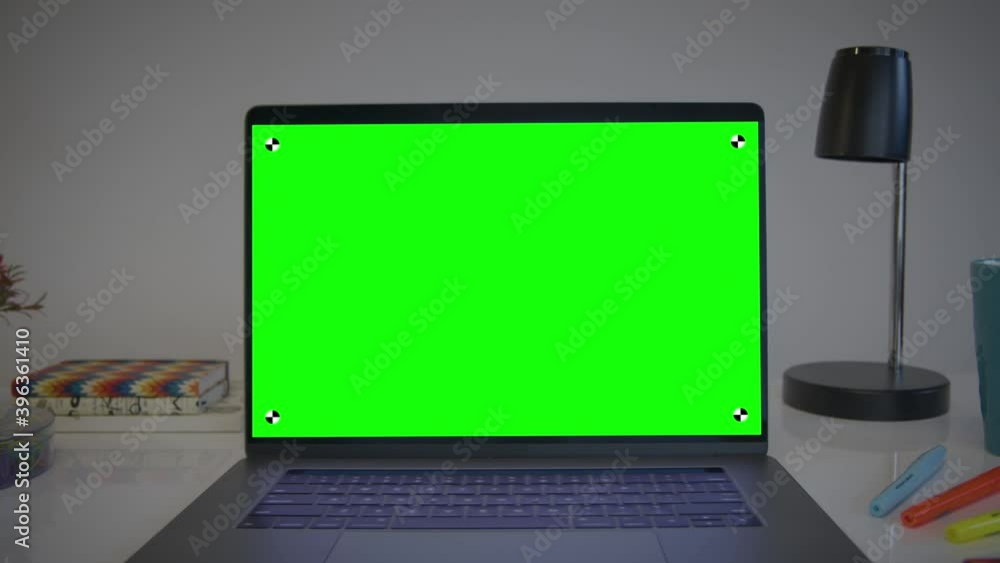 Laptop Computer Showing Green Chroma Key Screen. Colorful desk elements. Dolly in. Home office. Track points with perspective corner pin. Laptop Computer Showing Green Chroma Key Screen. Colorful desk elements. Dolly in. Home office. Track points with perspective corner pin.