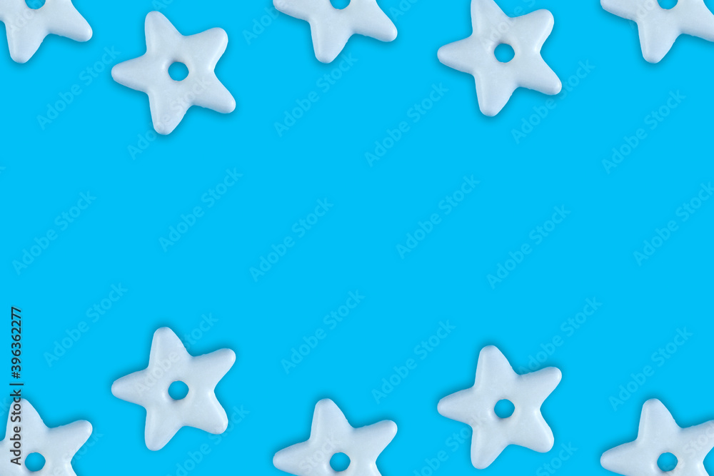 Christmas traditional cookies bakery star pattern on blue background.Concept banner frame border background for Christmas and New Year. Christmas traditional cookies bakery star pattern on blue background.Concept banner frame border background for Christmas and New Year.