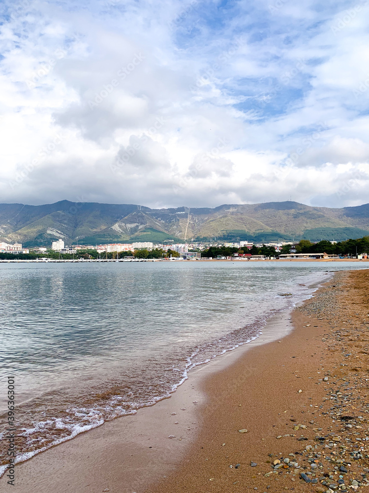 Sandy beach on the sea against the background of mountains