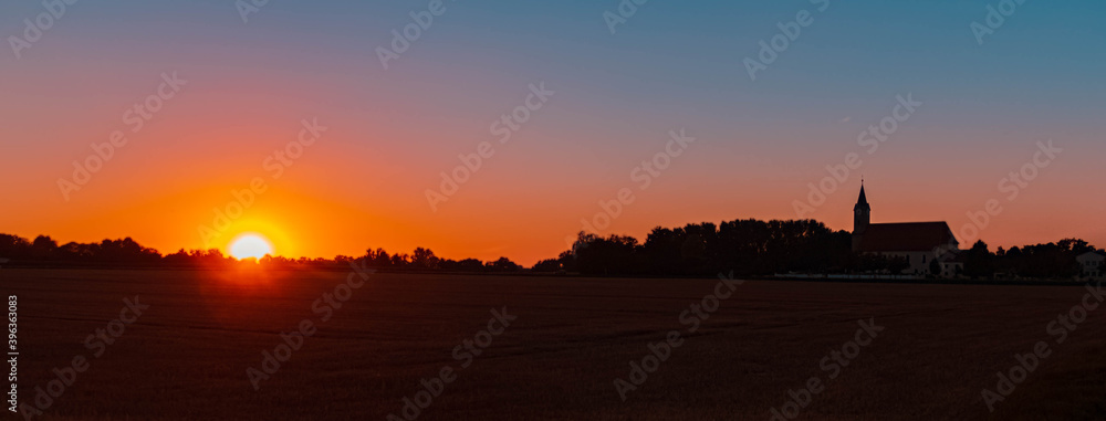 Beautiful sunset with a church silhouette near Moos, Bavaria, Germany