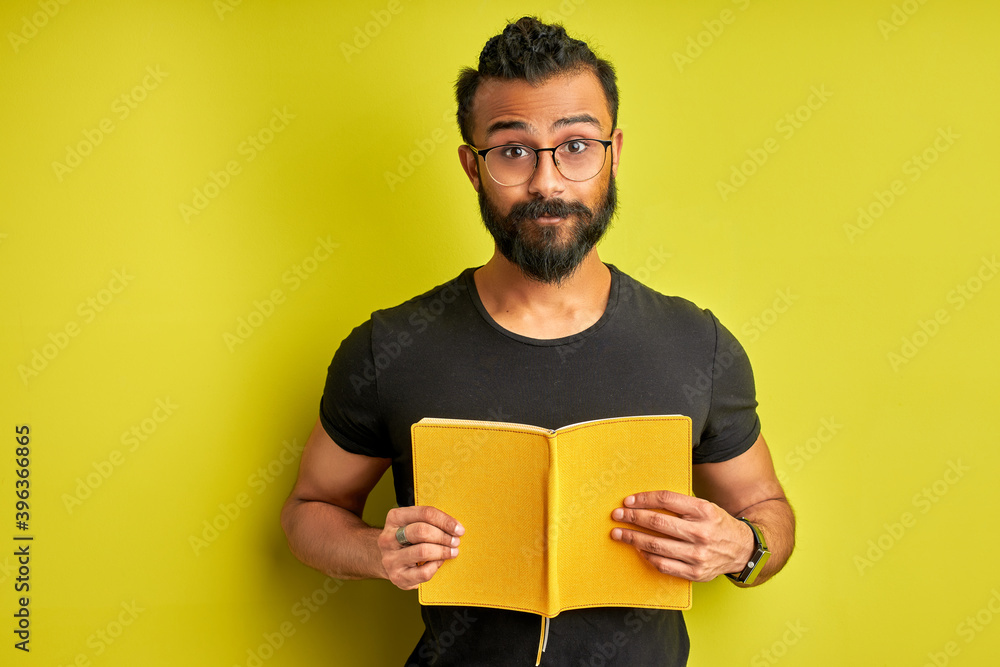 arabic guy with book in hands posing, young bearded male is ready to study. isolated on green background, people and education concept arabic guy with book in hands posing, young bearded male is ready to study. isolated on green background, people and education concept