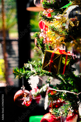 golden box on chrismas tree,decorations,window in background