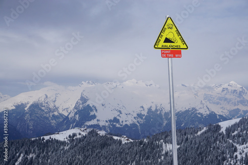 ski resort in the mountains of the French Alps with a fun sign for danger