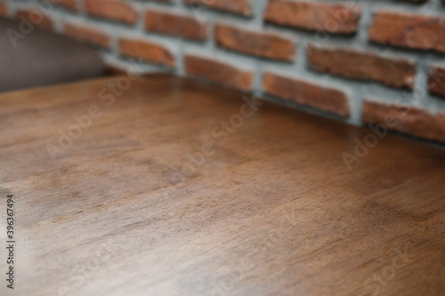 Dark wood table with red brick in background ,old natural pattern