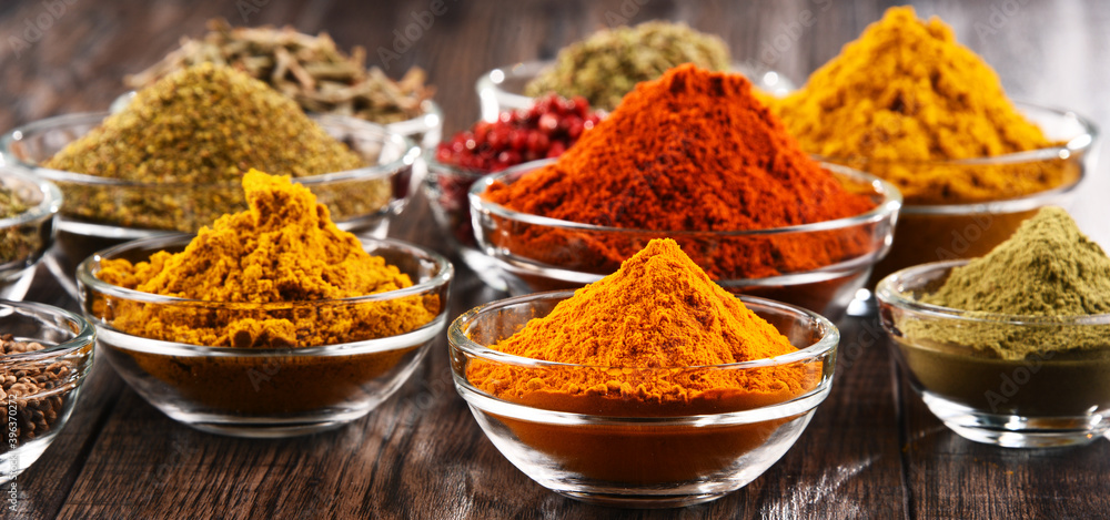 Variety of spices and herbs on kitchen table Variety of spices and herbs on kitchen table