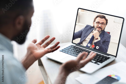 African Businessman Making Video Call Communicating With Coworker From Home