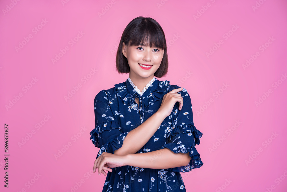 Asian attractive cute short hair woman happy smiling arms crossed confident independent strong mother businesswoman wearing casual dress pink isolated background in studio portrait looking into camera Asian attractive cute short hair woman happy smiling arms crossed confident independent strong mother businesswoman wearing casual dress pink isolated background in studio portrait looking into camera