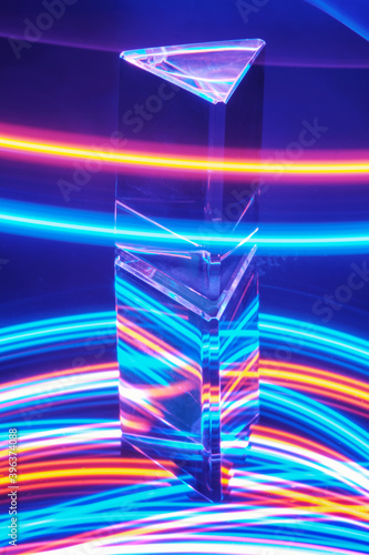 Glass Prism with reflection on a abstract colorful neon stripey background