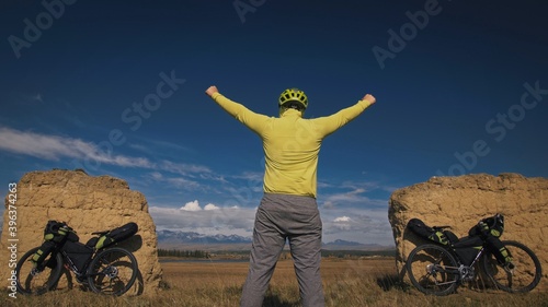 The man travel on mixed terrain cycle touring with bikepacking. The traveler journey with bicycle bags. Sport tourism bikepacking. photo