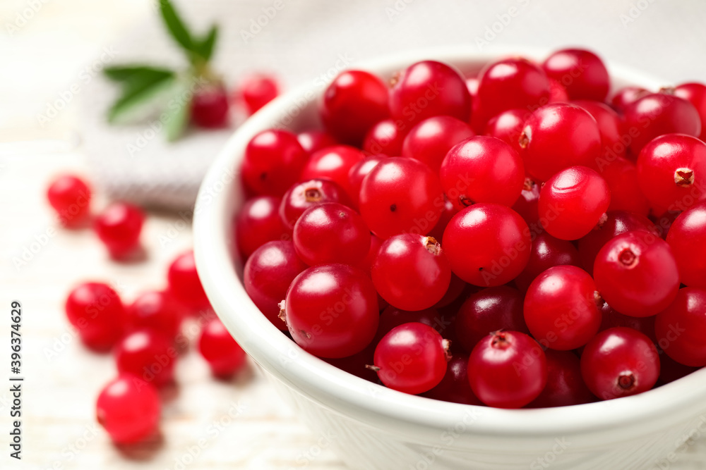Tasty ripe cranberries on white table, closeup Tasty ripe cranberries on white table, closeup