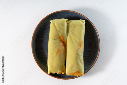 Fotografie typical chicken tamale on a plate isolated