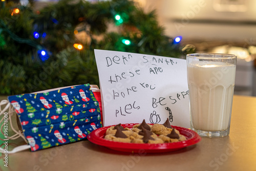 Milk, cookies and Covid 19 masks left by small child for Santa Claus