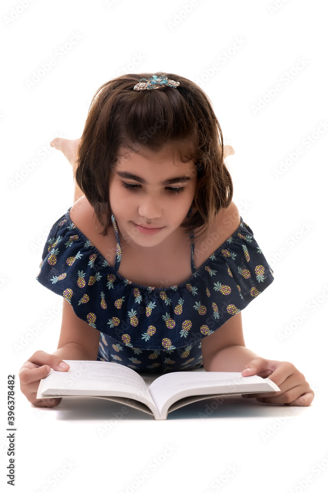 Hispanic small girl reading a book - Isolated on a white background Hispanic small girl reading a book - Isolated on a white background
