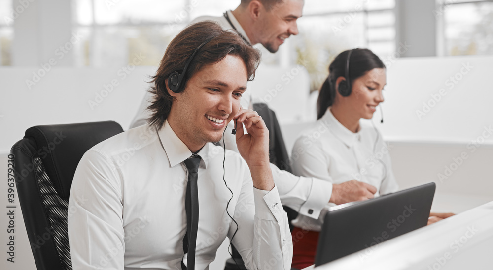 Friendly operator consulting client while working in call center Friendly operator consulting client while working in call center