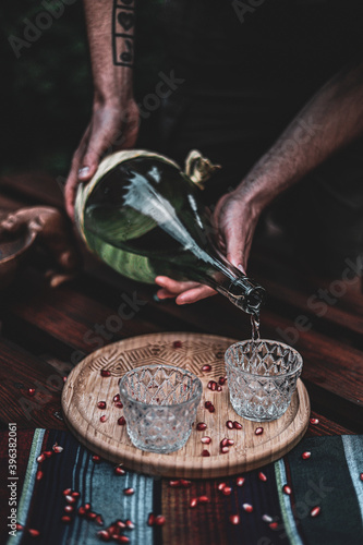Mezcal in a traditional mexican shot glass with some fresh fruits 
