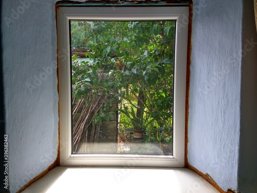 Rustic window with a view of the home yard