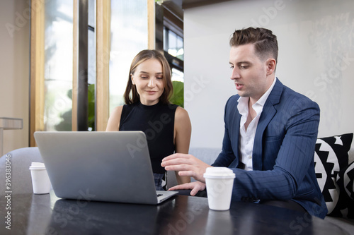 Caucasian Businessman Presents the Project to His Colleague or Customer on His Laptop