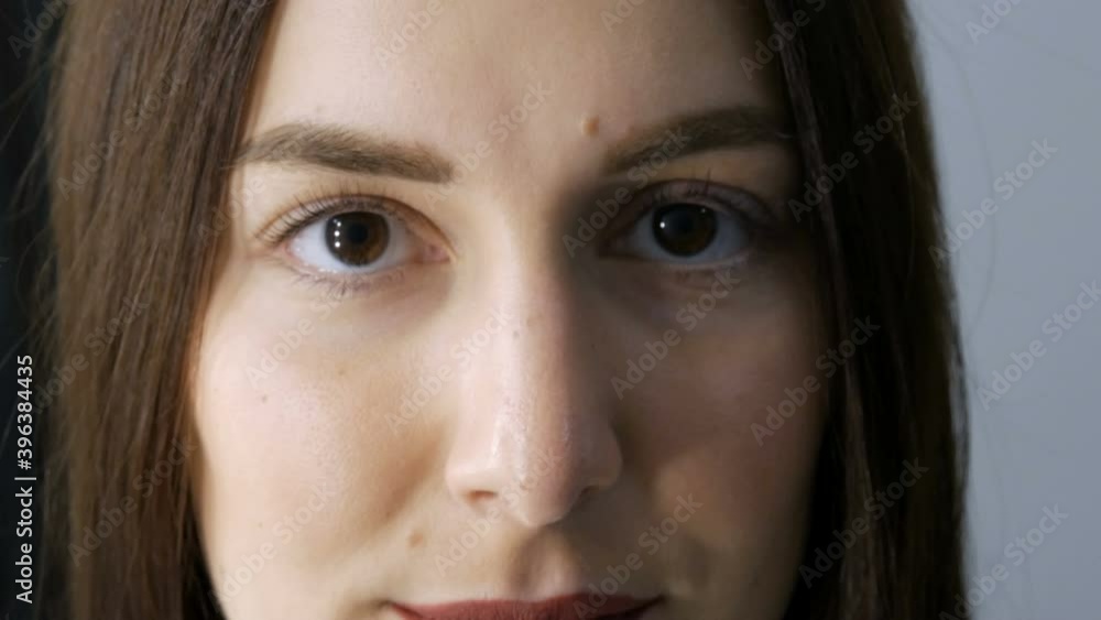 The face of a young girl before a modern eyelash lamination procedure in a professional beauty salon before the eyelash curling procedure. Portrait of a woman without makeup with dark lipstick. The face of a young girl before a modern eyelash lamination procedure in a professional beauty salon before the eyelash curling procedure. Portrait of a woman without makeup with dark lipstick.