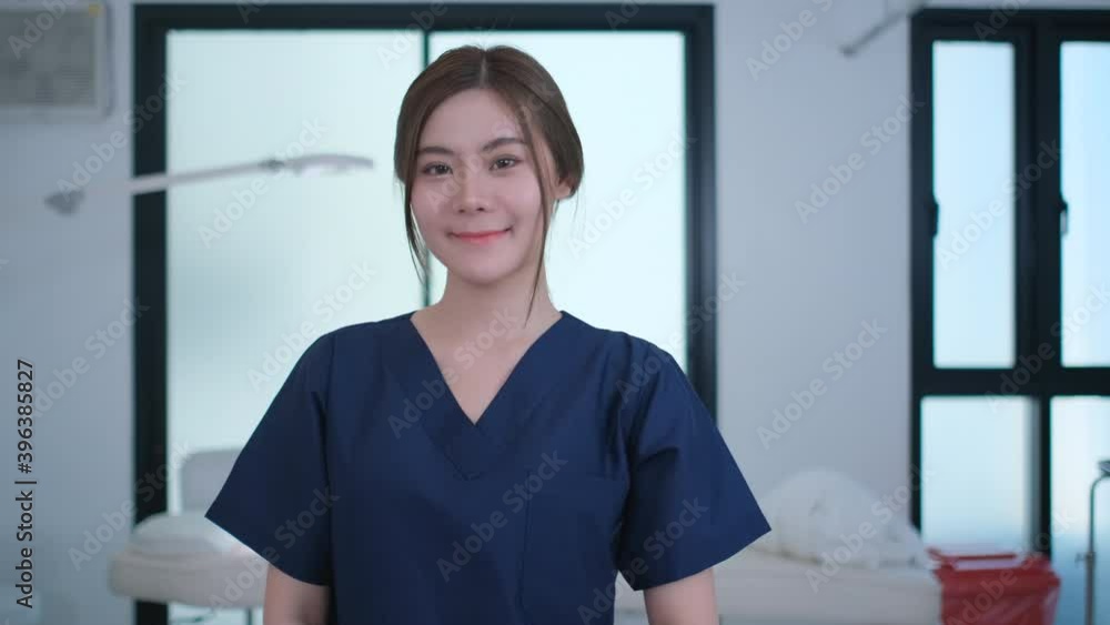 Portrait of beautiful Asian woman smile and stand in beauty clinic room also look to camera with confident action. She look like staff of clinic help to support and take care client, Asian beauty. Portrait of beautiful Asian woman smile and stand in beauty clinic room also look to camera with confident action. She look like staff of clinic help to support and take care client, Asian beauty.