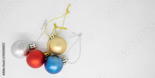 Multi-colored Christmas balls-decorations on a white background. Christmas composition