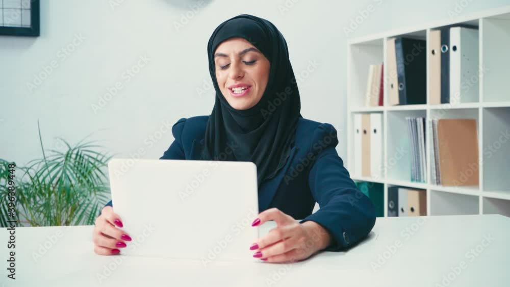 Muslim businesswoman having video call on digital tablet Muslim businesswoman having video call on digital tablet
