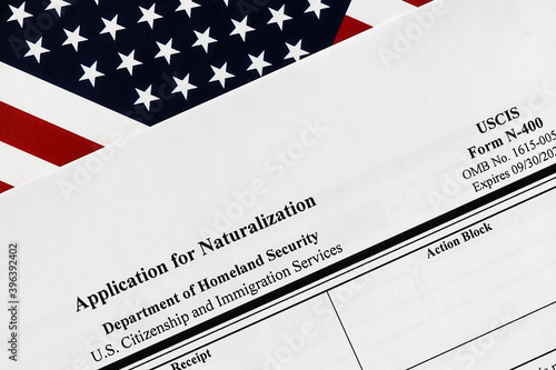 close-up of n-400 form. application for naturalization topview, on a background of United States flag.