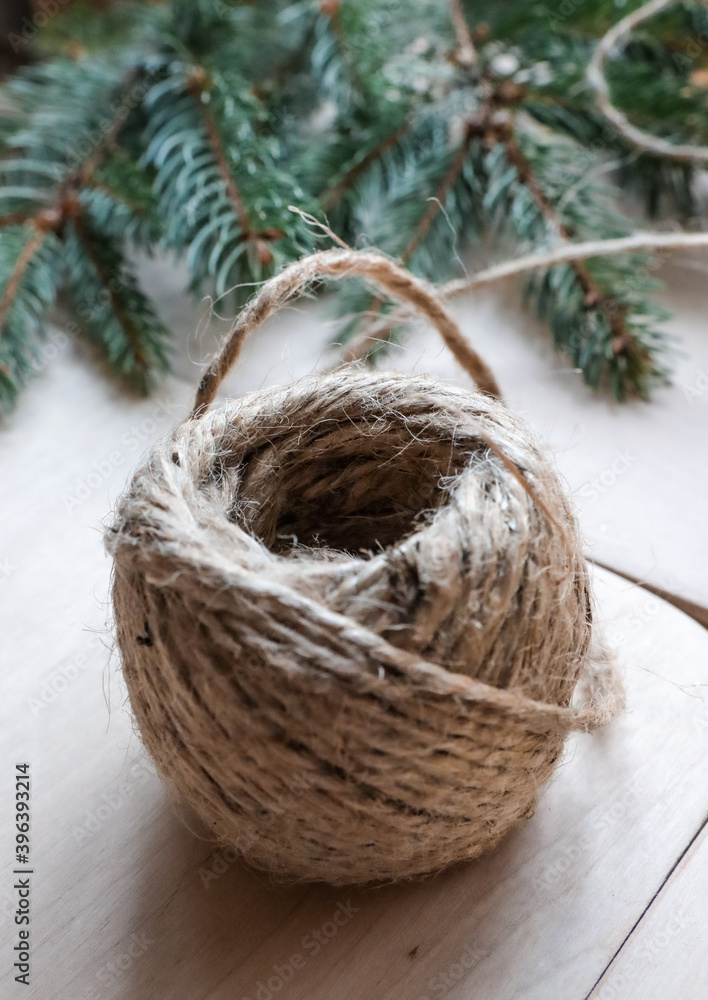 A ball of decorative threads lies on a wooden table. A ball of decorative threads lies on a wooden table.