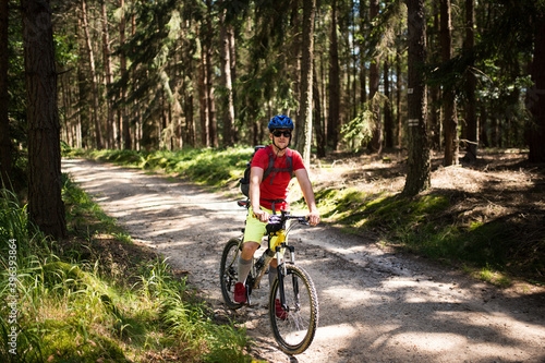 Young athlete man with bicycle in the nature.